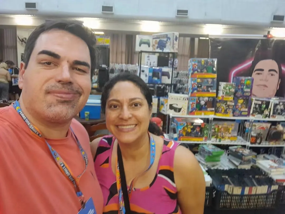 Lojistas da Live do Prince no estande, cercados de consoles e action figures